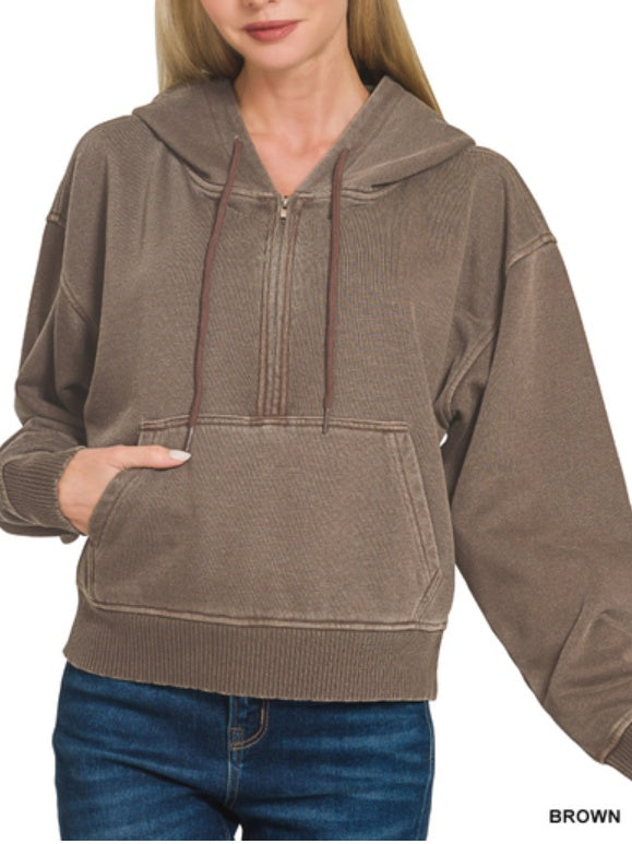 Brown hoodie worn by a person on a white background